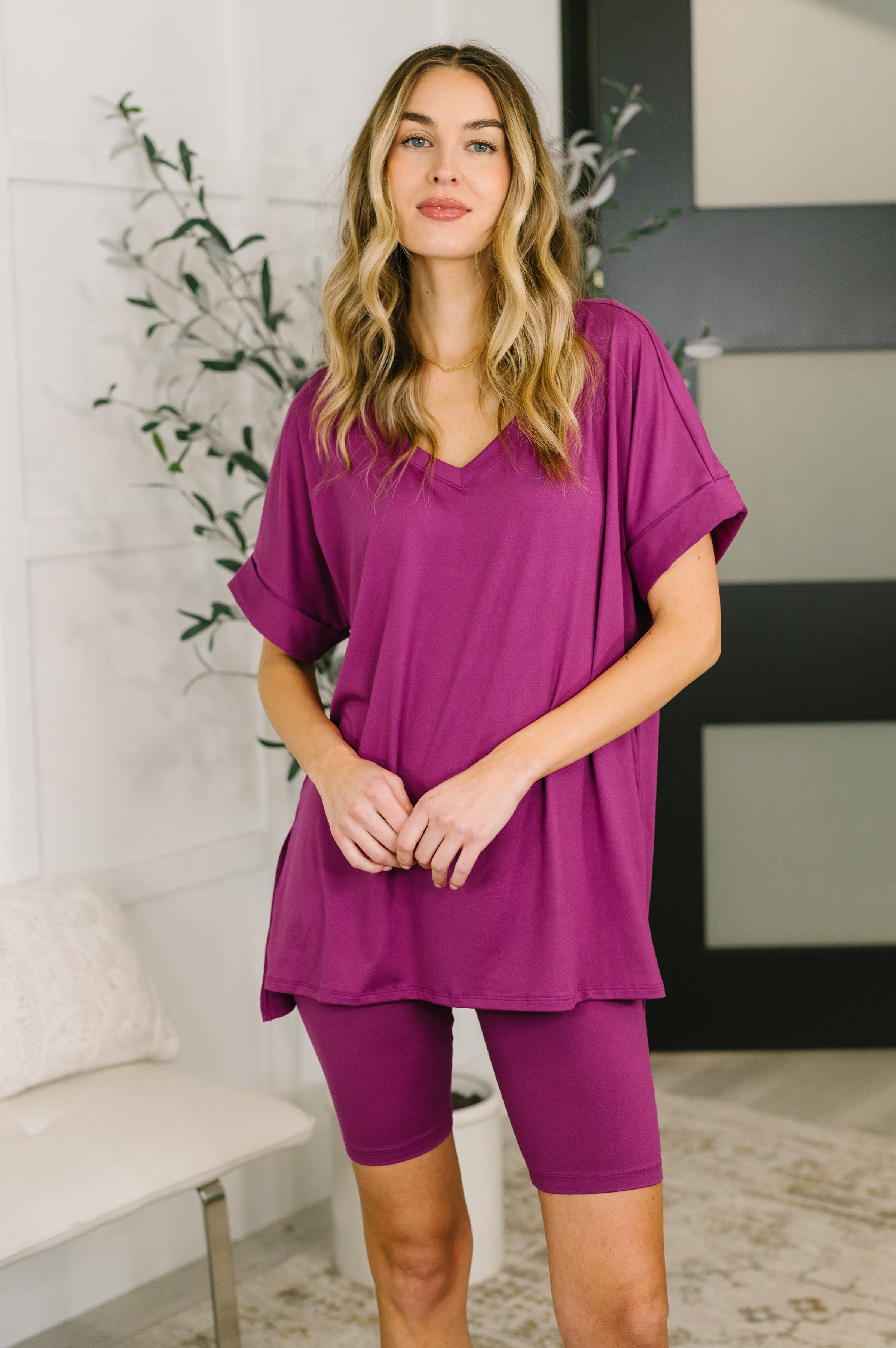Light plum buttery soft bike short set with V-neck top, dolman sleeves, and relaxed stretchy fit.