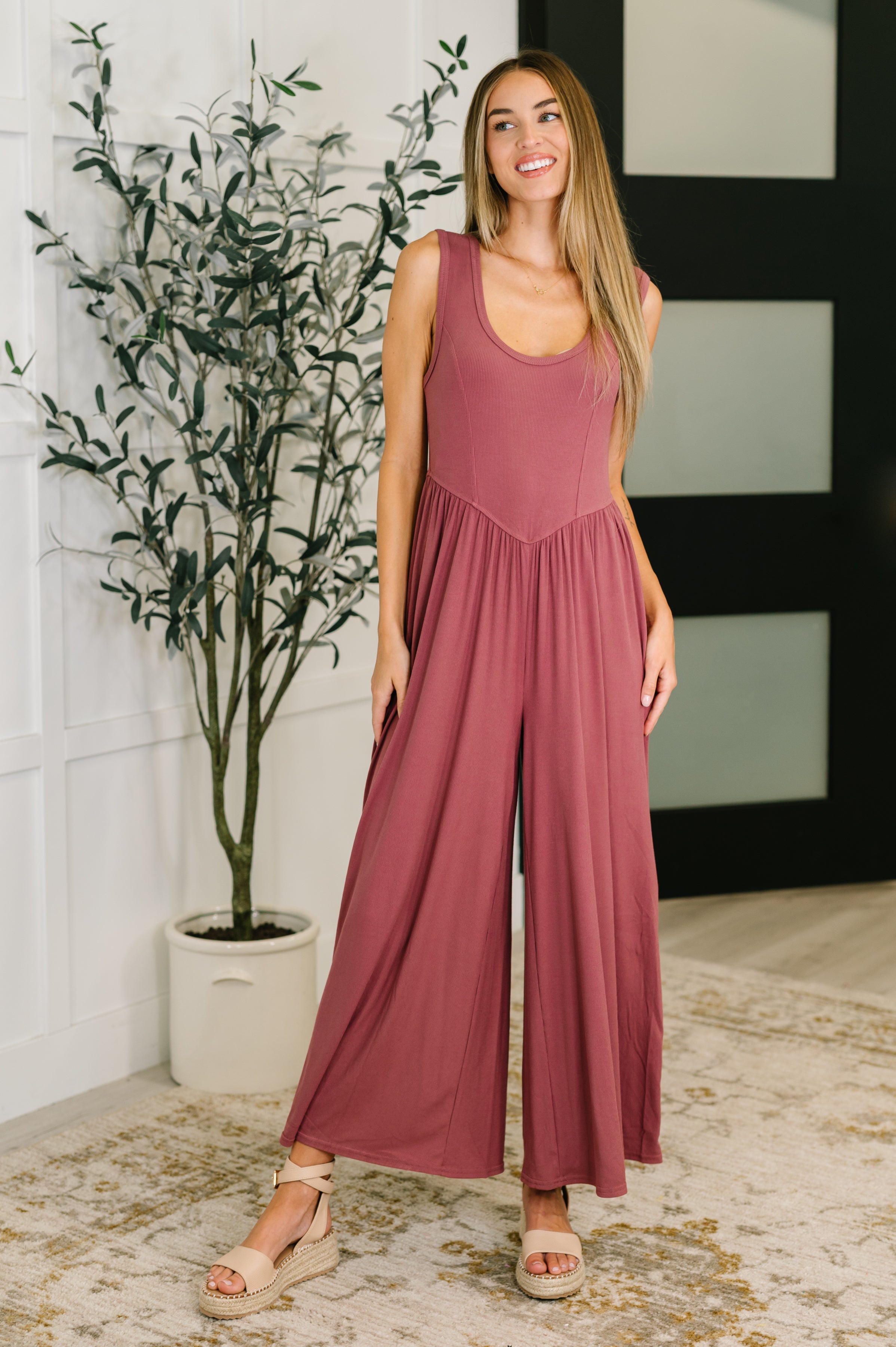 Mauve wide leg jumpsuit with ribbed knit fabric, elastic waist, and relaxed flattering fit.