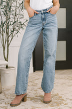 Judy Blue mid rise straight leg jeans with distressed hem and structured stretch rigid magic denim.