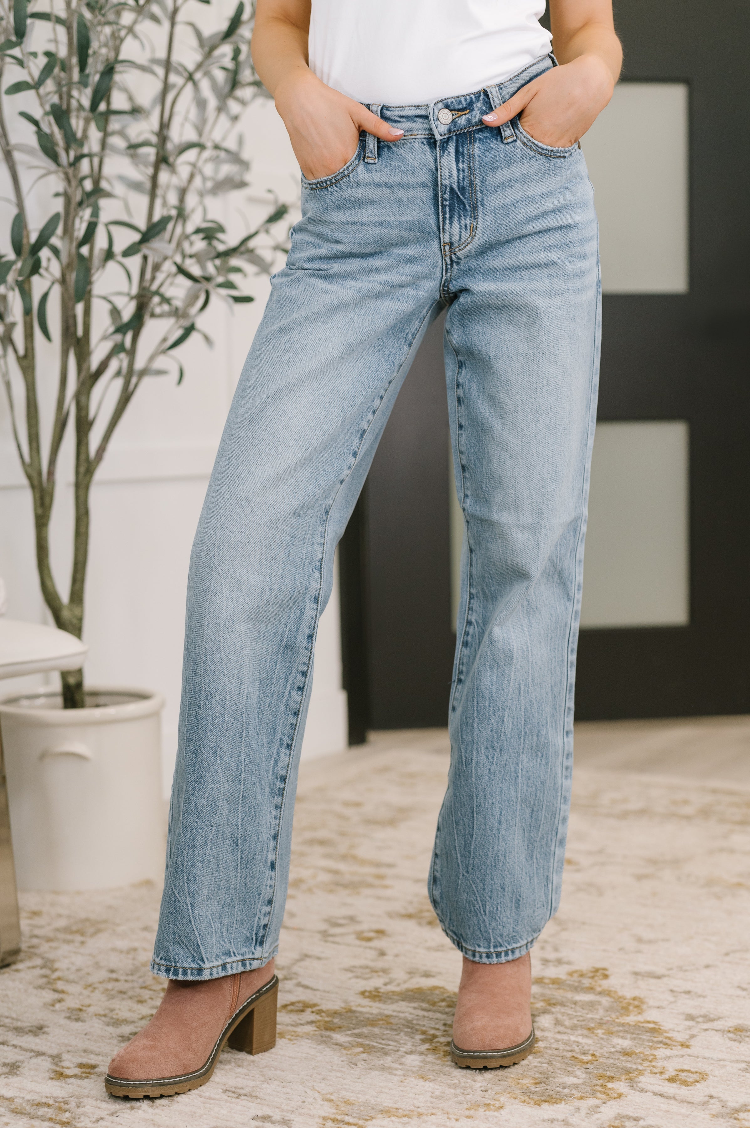 Judy Blue mid rise straight leg jeans with distressed hem and structured stretch rigid magic denim.