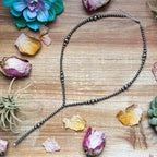 Handmade sterling silver pearl lariat necklace with graduated pearls, adjustable extender, and western-inspired pearl drop design.