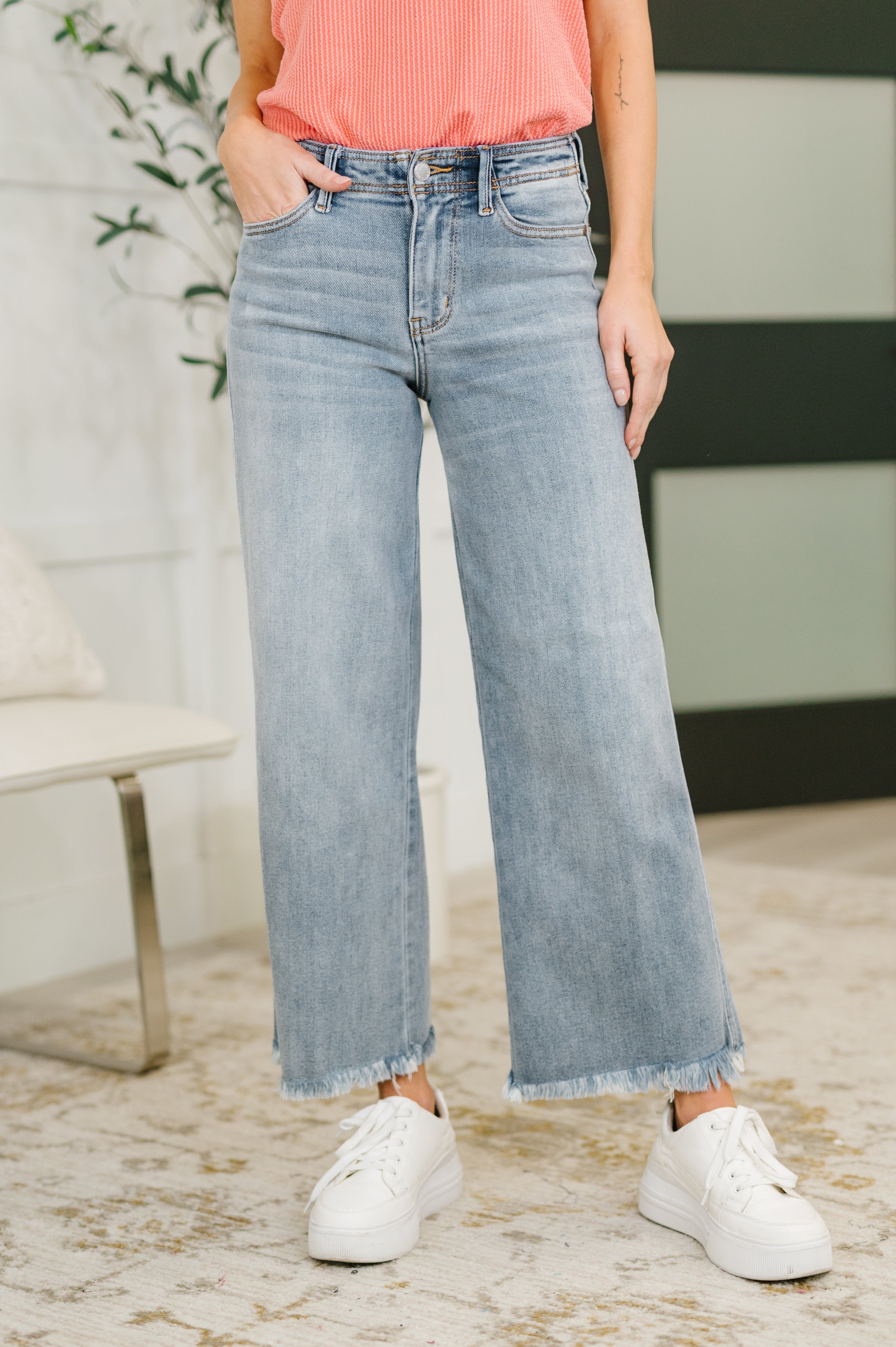 Judy Blue mid rise wide leg jeans with frayed ankle hem, relaxed fit, and stretchy denim comfort.