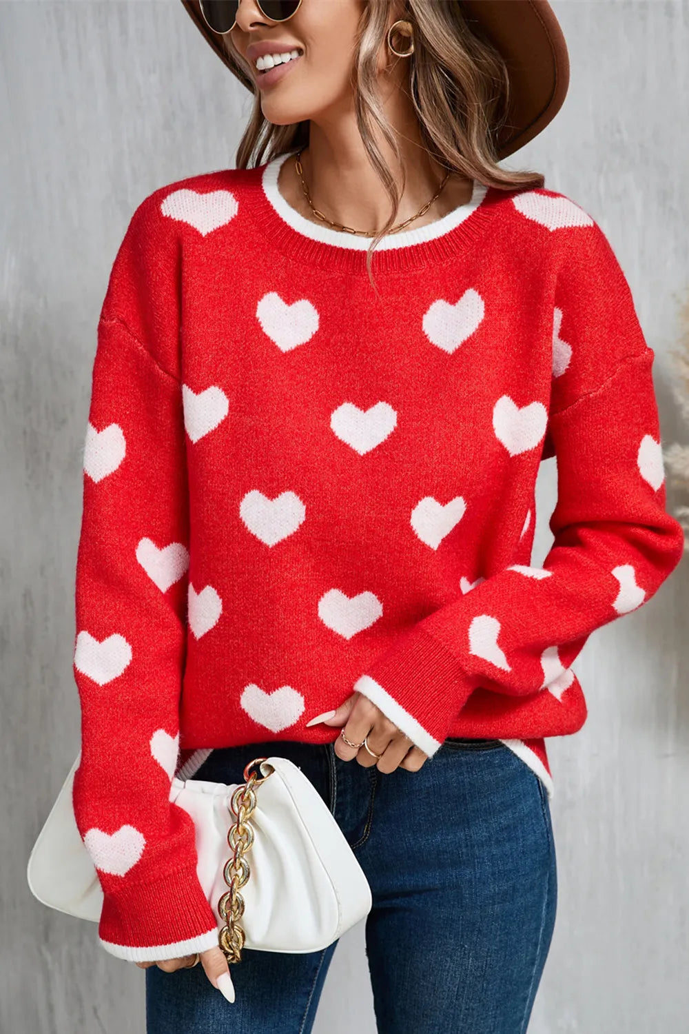 Red long sleeve pullover sweater with white heart print. Soft knit, classic round neckline, Valentine’s Day-ready with a casual comfy fit.