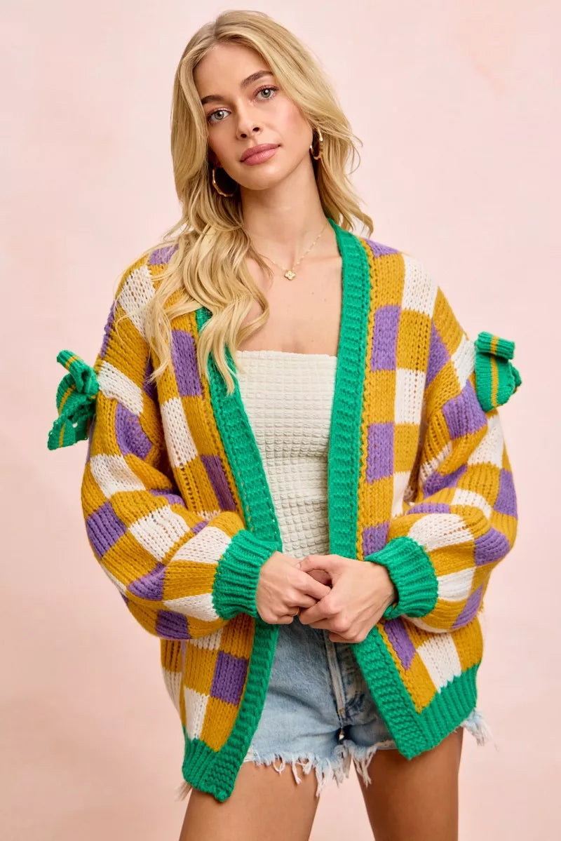 Women’s open front cardigan with Mardi Gras checkerboard pattern, soft knit fabric, relaxed fit, bold casual layering piece for everyday and western casual style.