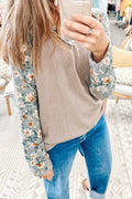 Beige rib-textured blouse with blue long sleeves and cream floral print. Soft, opaque, relaxed fit, casual everyday top.