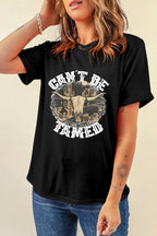 Black western graphic tee with a rugged “Can’t Be Tamed” skull by an old barn. Edgy staple that pairs effortlessly with jeans, boots, vests, and casual country fits.