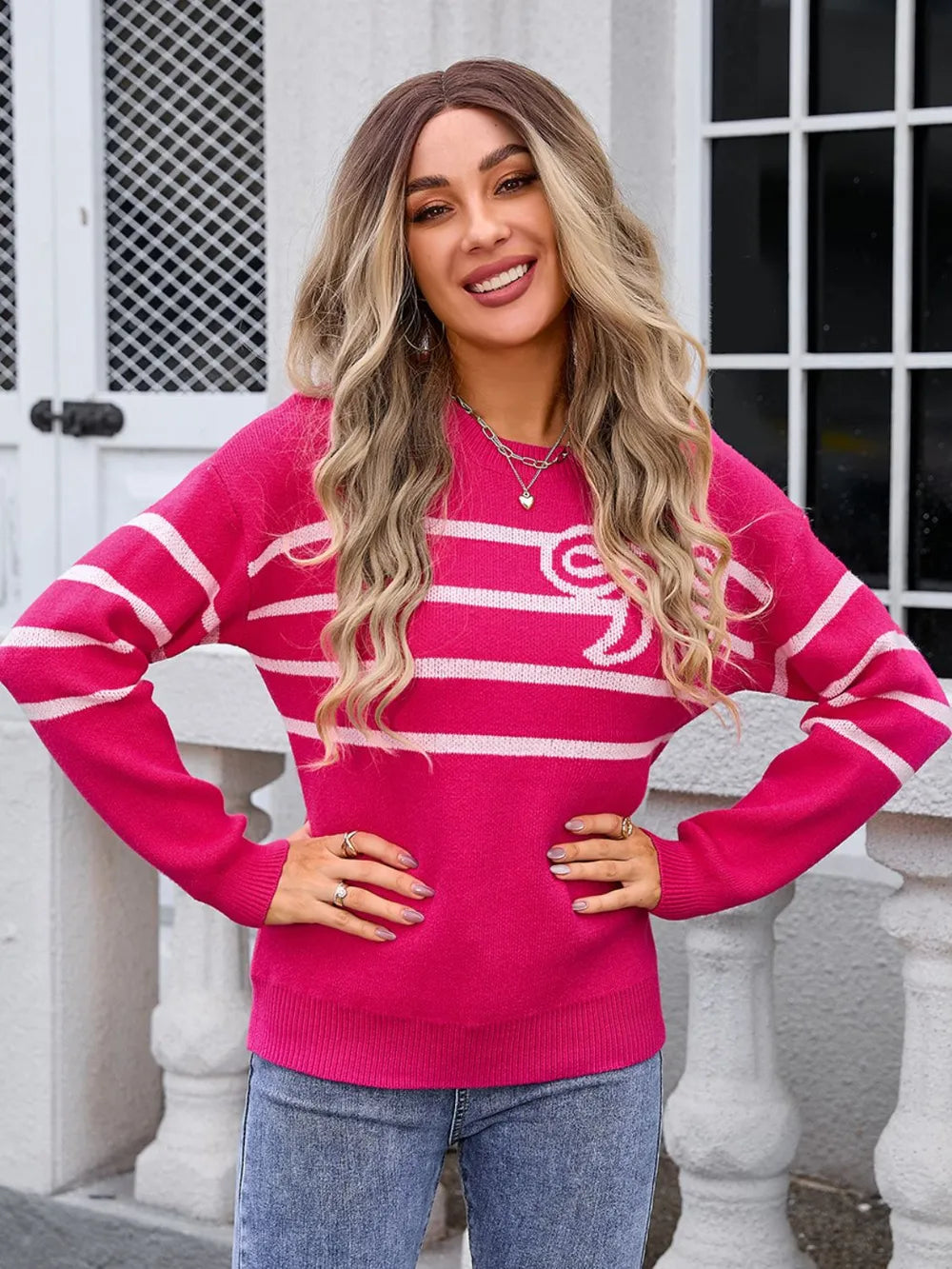 Deep rose stretch-knit sweater with a white chest stripe and side bow accent. Soft cozy pullover with warm pink tone, long sleeves, and boutique-style contrast.