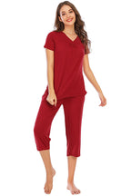 Solid scarlet red 2-piece lounge outfit with a V-neck short sleeve top and capri pants. Soft, opaque, stretchy rayon knit with pockets and a relaxed fit.