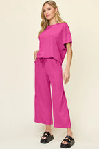 Hot pink textured tee and pocketed wide leg pants. Bold, comfy, and cute for bleachers, errands, and cowgirl-casual style.