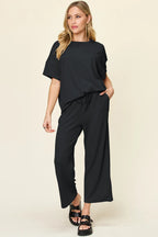 Black textured round neck tee and wide leg pants with pockets. Clean, relaxed, and easy to style up or down.