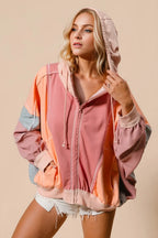 Burnt coral hoodie with peach and grey muted color block panels. Zip front, pockets, drawstring hood, and western casual comfort.
