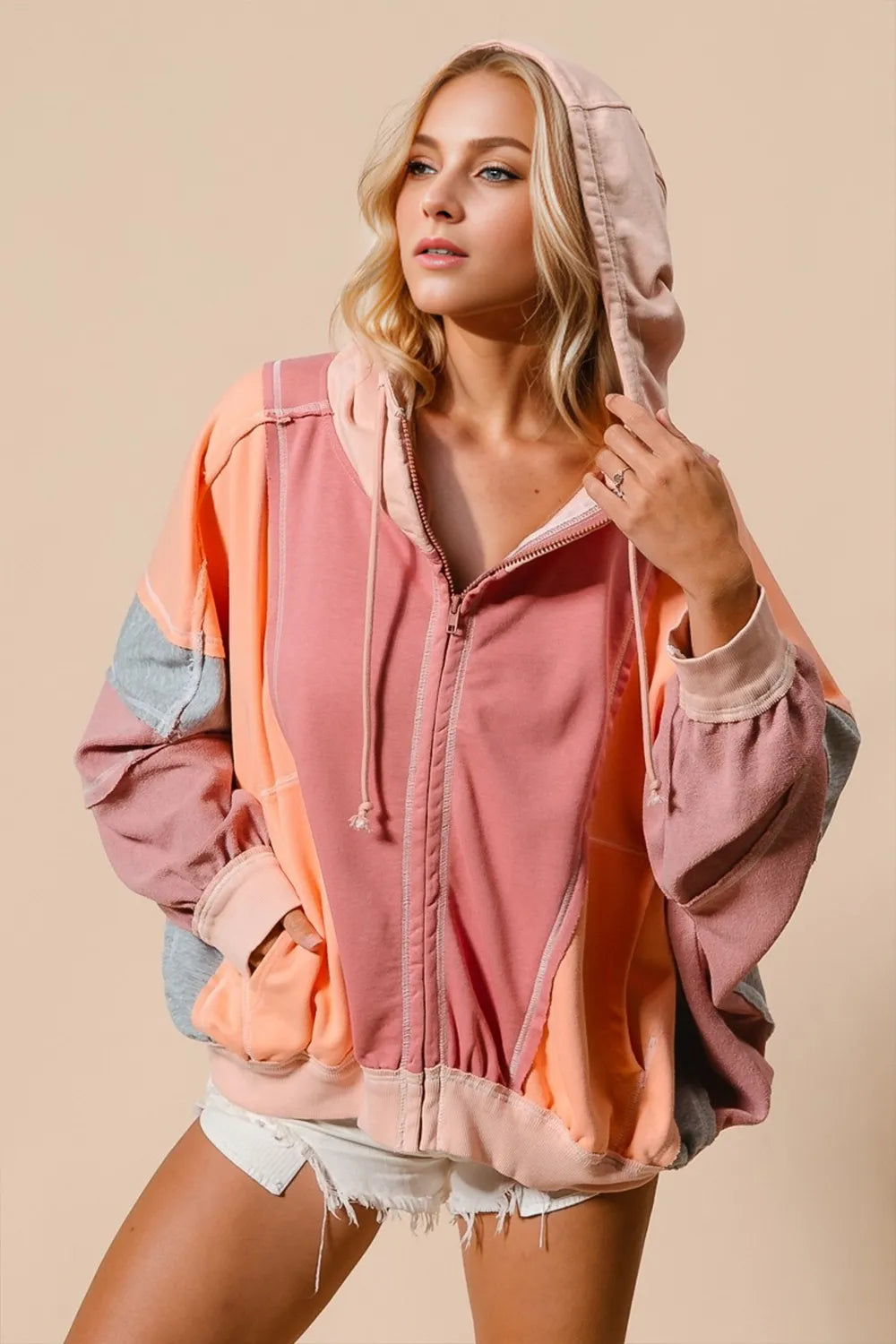 Burnt coral hoodie with peach and grey muted color block panels. Zip front, pockets, drawstring hood, and western casual comfort.