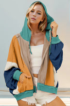 Khaki hoodie with mustard, teal, navy, and ivory color block panels. Zip front, drawstring hood, and pockets for a bold western casual look.