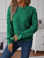 Dark green long sleeve knit sweater with ribbon detail woven down both sleeves. Soft, opaque pullover with a classic round neckline.