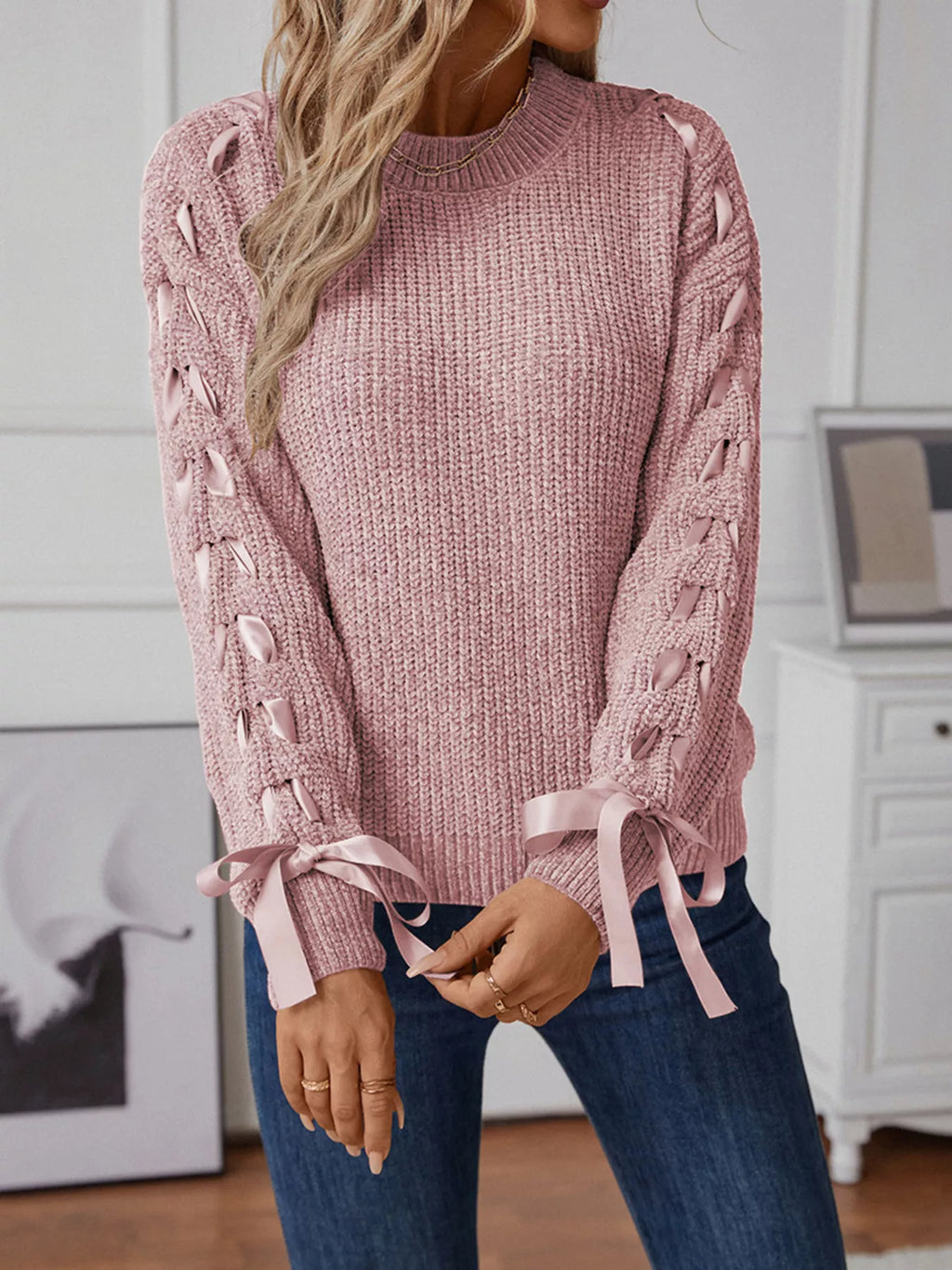 Dusty pink long sleeve knit sweater with ribbon detail woven down both sleeves. Soft, opaque pullover with a classic round neckline.
