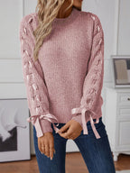 Dusty pink long sleeve knit sweater with ribbon detail woven down both sleeves. Soft, opaque pullover with a classic round neckline.