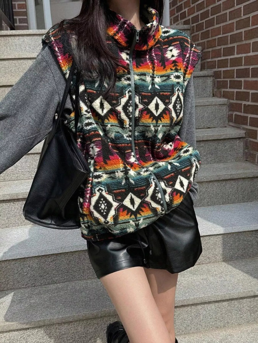 Women’s black geometric print fleece zipper vest, cozy casual outerwear layer with vibrant patterned design for everyday comfort.