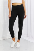 Black high-stretch leggings with reflective dot detail and side pockets. Opaque, durable seams, smoothing 5-inch waistband, athleisure-to-workout fit.