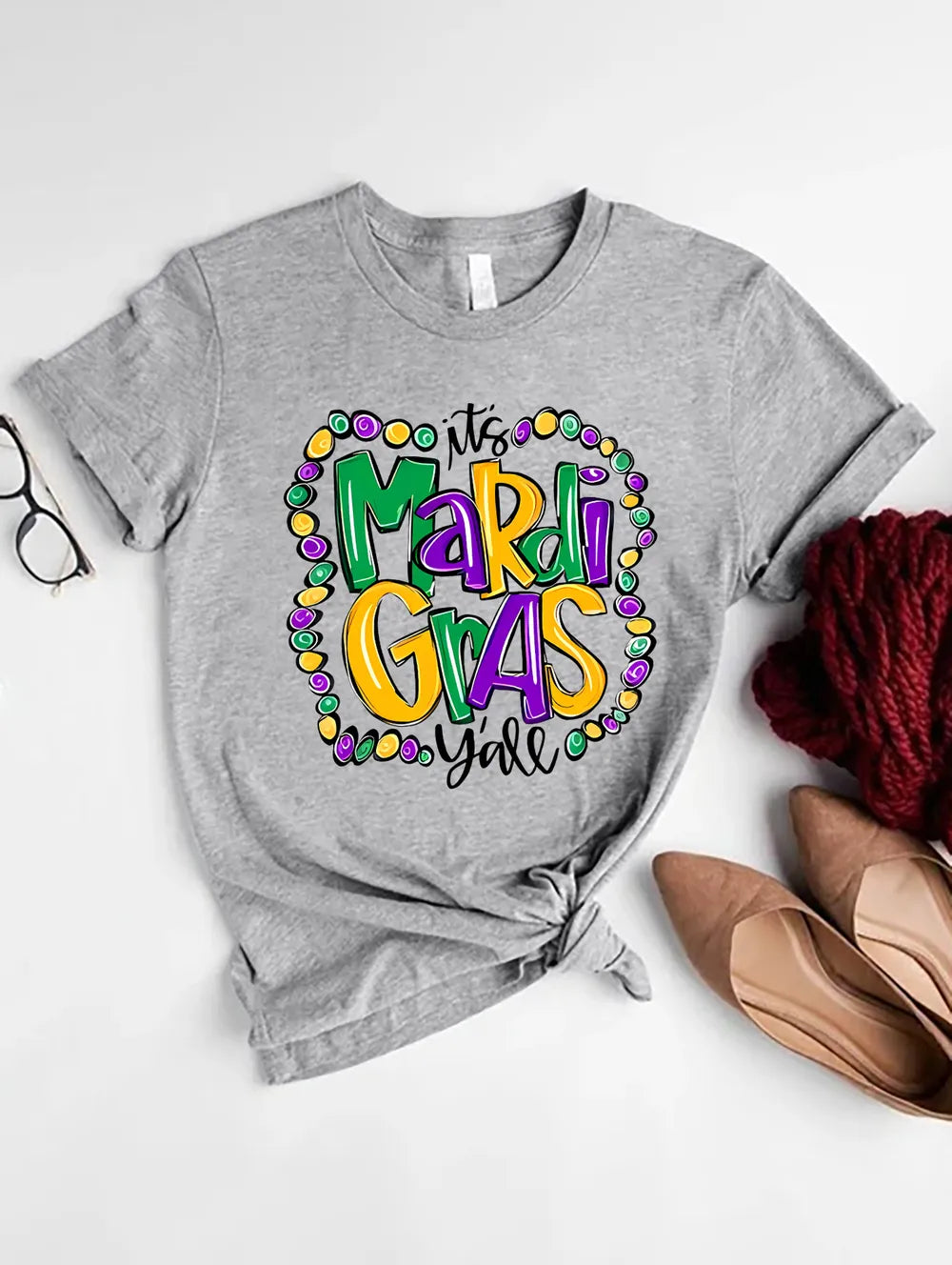 Gray graphic tee with festive “Mardi Gras Y’all” design. Soft stretch fit, easy everyday parade-season styling.