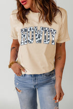 Light apricot western graphic tee featuring “Howdy” in black and white cow print. Cute, soft, and effortless to style with denim, boots, and caps.