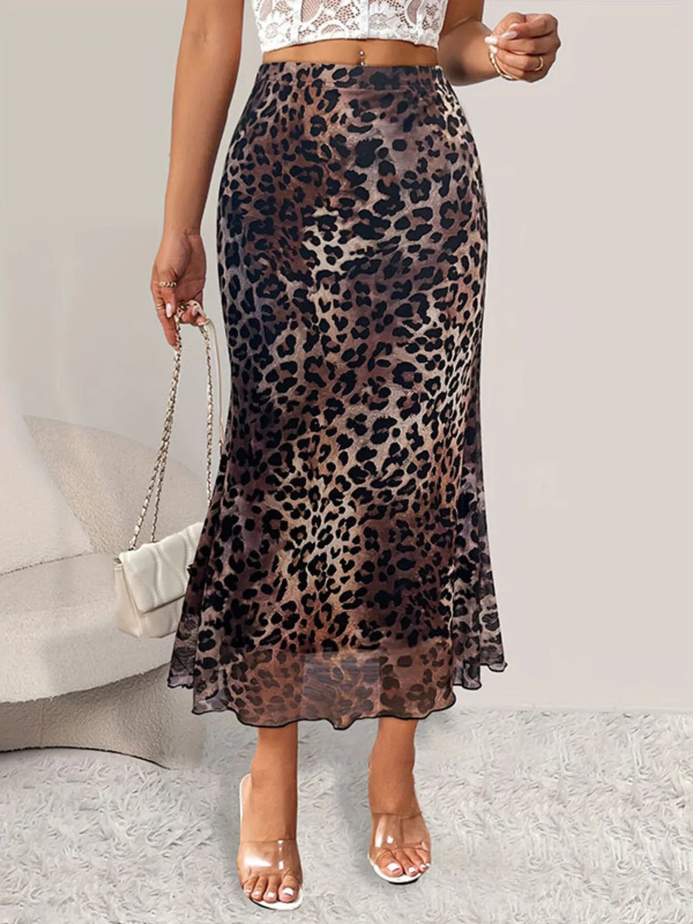 Lined stretch-fit leopard print mermaid midi skirt with a soft ruffled hem and a sculpted silhouette, styled for versatile everyday and elevated western-casual looks.