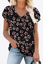 Black V-neck blouse with pink cherry blossom print. Petal sleeves, highly stretchy soft knit, everyday boutique top.