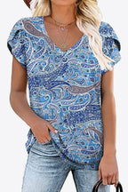 Cobalt blue paisley printed blouse with gray and white accents. V-neck, petal sleeves, soft high-stretch knit.