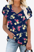 Dark navy blouse with pink and yellow floral print. Soft petal sleeves, stretchy rayon-blend knit, everyday boutique top.