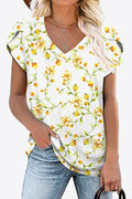 Ivory V-neck blouse with yellow floral print and petal sleeves. Soft stretch rayon-blend knit, short sleeve everyday spring top.
