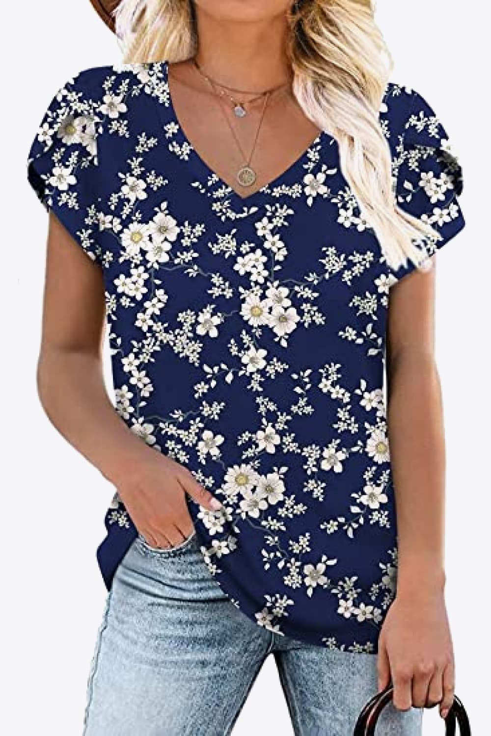 Navy blouse with tiny white floral print. Petal sleeves, high stretch knit, soft casual everyday boutique top.