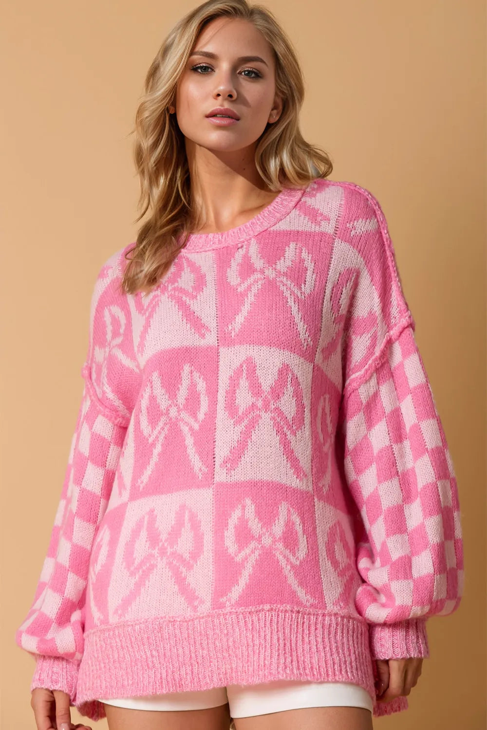 Women’s pink checkered long sleeve sweater with bow detail, soft knit fabric, retro casual layering top for everyday cozy outfits.