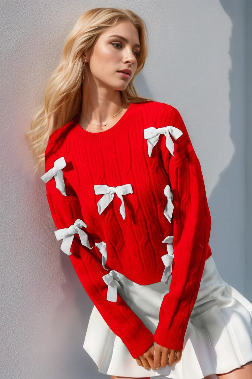 Women’s red knit sweater with white stitched bow details, long sleeves, soft casual-retro layering top for everyday cozy outfits.