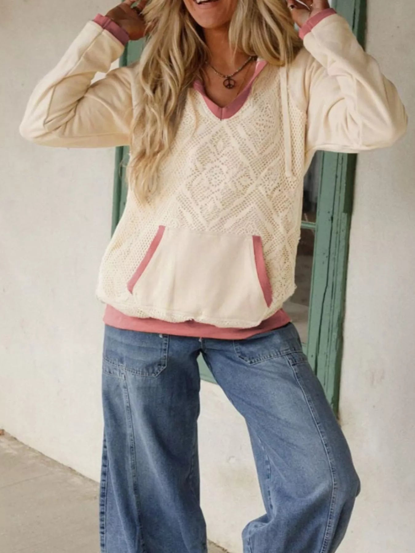 Cream sweater-knit hoodie with lace crochet panels and blush rose-pink trim. Kangaroo pocket, feminine detail with a soft, relaxed everyday fit.