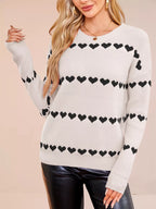 Ivory long sleeve knit sweater with 4 rows of black hearts. Relaxed dropped shoulder fit, soft, opaque, everyday pullover style.