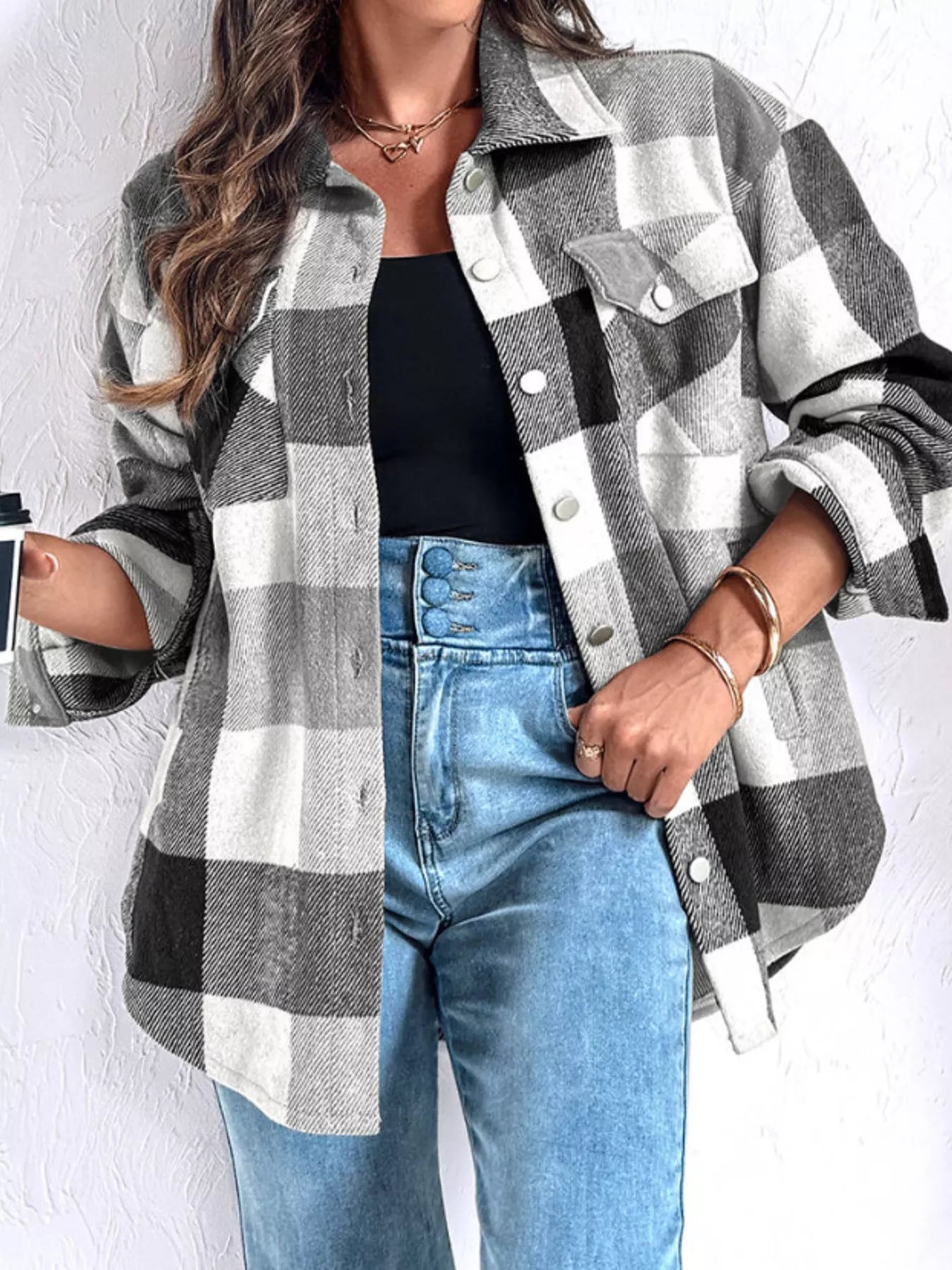 Black, white, and gray plaid button-up with long sleeves and front pockets. Opaque, soft, relaxed fit, everyday casual shirt.