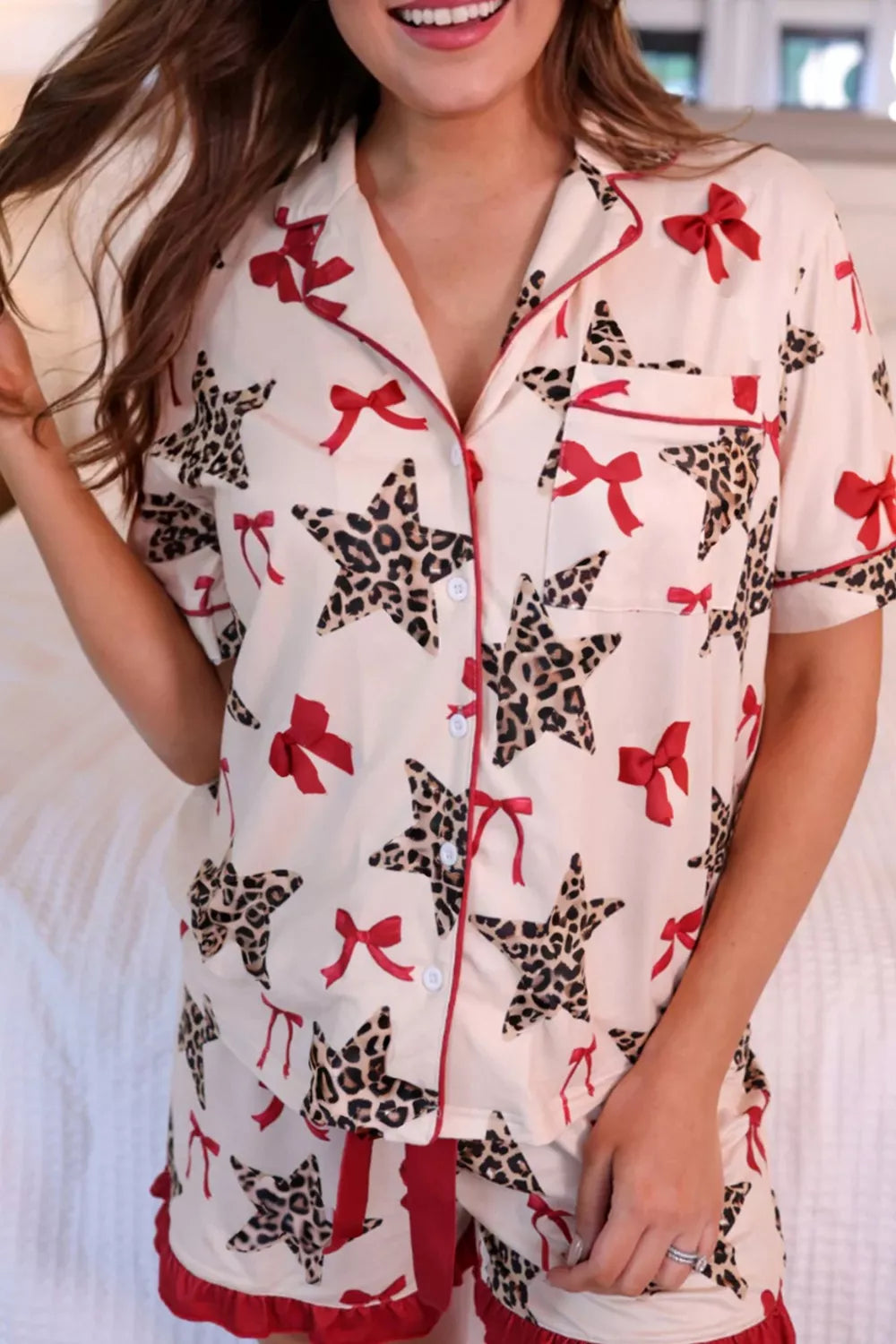 Short sleeve button-up lounge top with pockets and frill shorts. Star print with leopard accents and red bows throughout. Soft, opaque, comfy fit.