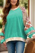 Teal raglan long sleeve top with printed patchwork sweater-style design. Western-boutique layering staple with a soft, slightly stretchy casual fit.