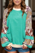 Teal raglan long sleeve top with printed patchwork sweater-style design. Western-boutique layering staple with a soft, slightly stretchy casual fit.