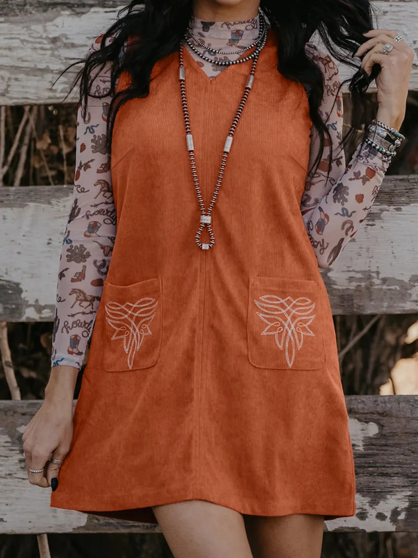 Women’s terracotta corduroy shift dress with boot-stitch pockets, casual western everyday outfit with classic textured fabric.
