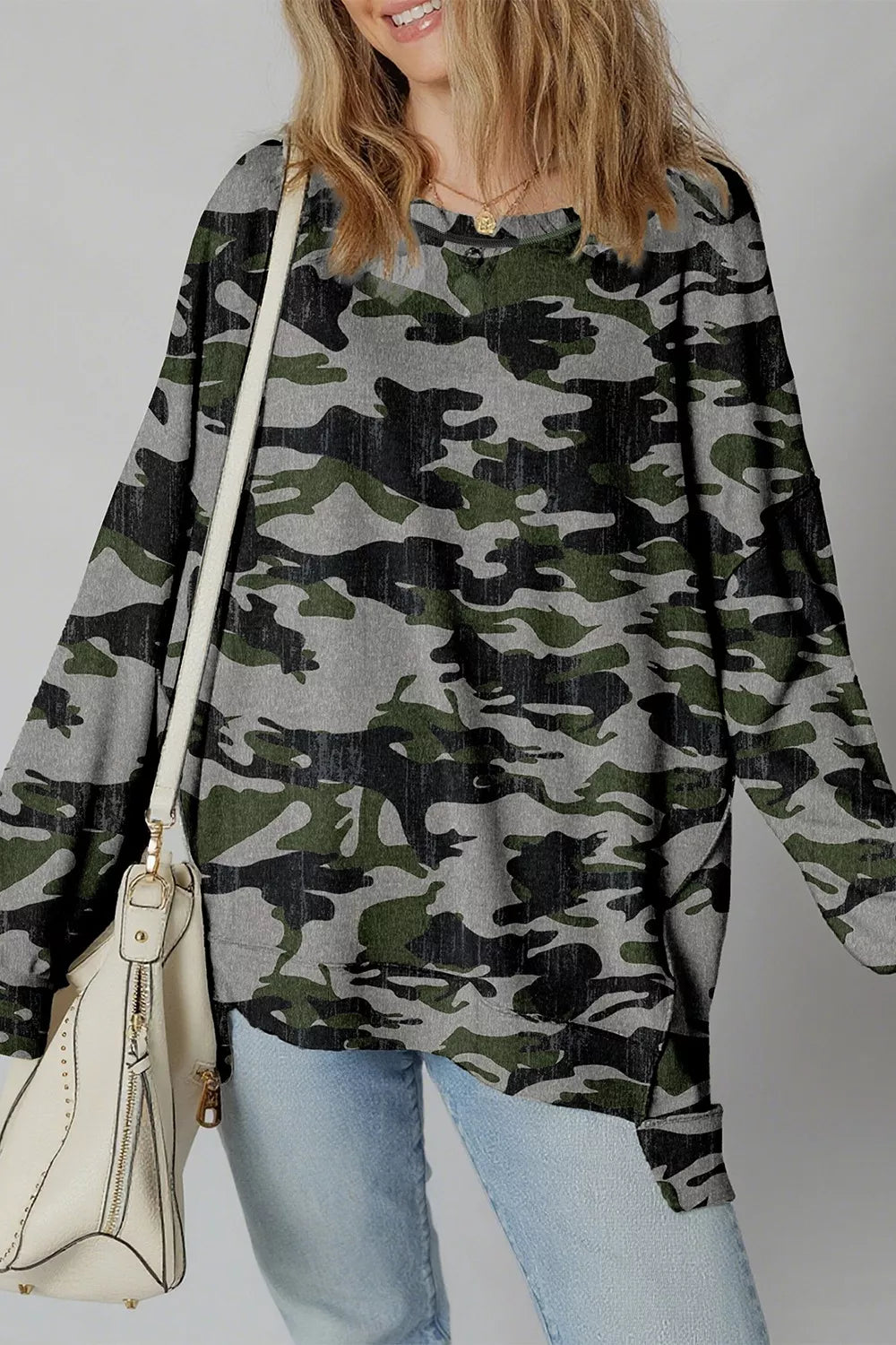 Green, gray, and black abstract woodland camo pullover with long sleeves and a relaxed high-low fit. Soft, opaque, slightly stretchy, and easy to wear every day.