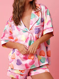 Women’s button-up pajama shirt and lounge shorts set in Valentine hearts print, soft fabric, relaxed fit, cute cozy sleepwear for home lounging and casual nights